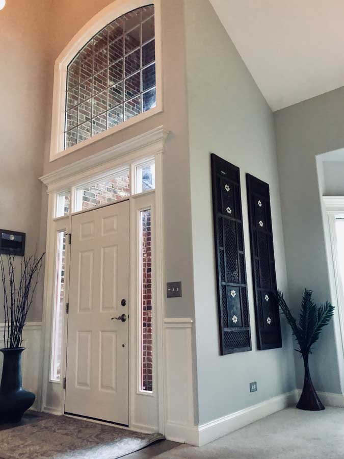 Freshly painted bright entryway with arched openings